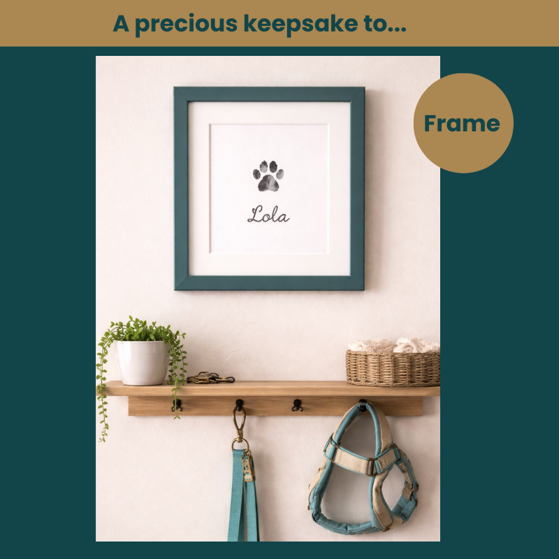Image of a framed and hanged picture of a paw print with the name, Lola, at the bottom. The frame hangs above a shelf that hangs a dog's lead and harness. Text at the top reads, 'A precious keepsake too...' Text in a circle reads, 'Frame.'